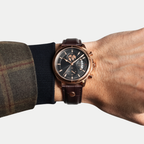 Breckmont Meridian rose gold men's dress watch on wrist black dial brown leather strap