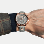Breckmont Meridian rose gold men's dress watch on wrist green leather strap
